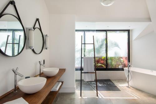 a bathroom with two sinks and a mirror at Villa Paranaguá Hotel & Spa - Boutique Hotel in Rio de Janeiro