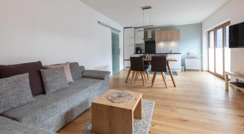 a living room with a couch and a table at Haus am Stein in Oetz