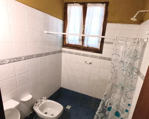 a bathroom with a toilet and a sink at Casa de Veraneo en Villa La Bolsa in Villa Anizacate