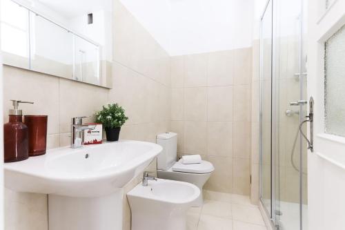 a white bathroom with a sink and a toilet at Almirante Balcony by Homing in Lisbon
