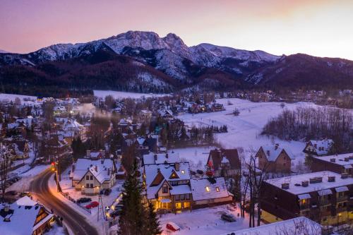 an aerial view of a town in the snow with mountains at Serce Tatr Residence Zakopane - blisko Krupówek in Zakopane