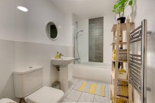 a white bathroom with a toilet and a sink at Stylish Sheffield City Spot in Sheffield