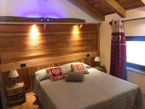 a bedroom with a bed with a wooden wall at Au Coin Du Chateau in Châtillon