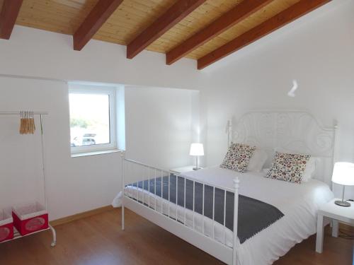 a white bedroom with a white bed and a window at Gold - Private Pool - 18 Guests - Albufeira in Albufeira