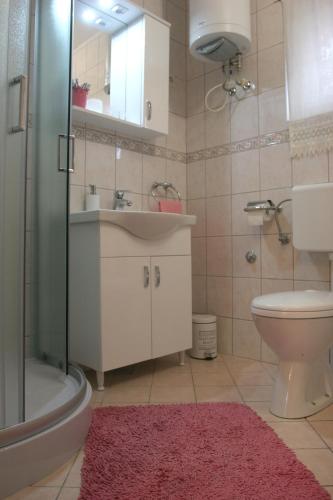 a bathroom with a sink and a toilet and a shower at STUDIO APARTMAN MARIA in Čavle