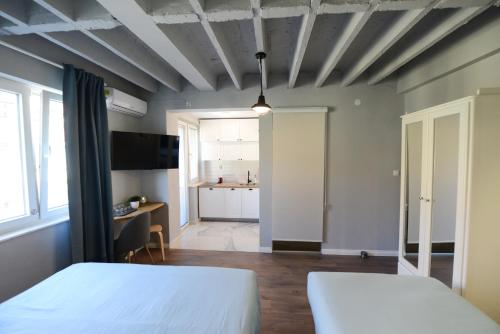 a bedroom with a bed and a kitchen in the background at Skopje Arch Residence in Skopje