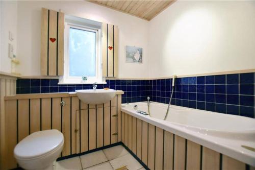 a bathroom with a toilet and a tub and a sink at Unique, perfectly located town centre house in Lerwick