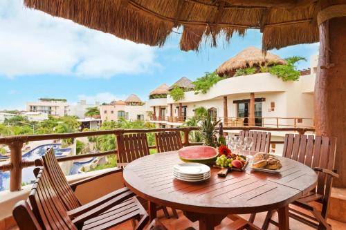a table on the balcony of a villa at Porto Playa Condo Hotel and Beach Club in Playa del Carmen