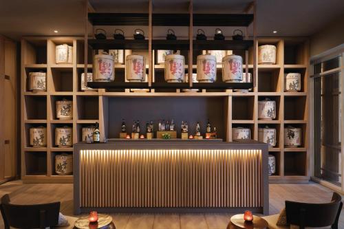a bar in a room with shelves of bottles at Secrets La Romana All-Inclusive Adult Only Resort & Spa in Bayahibe