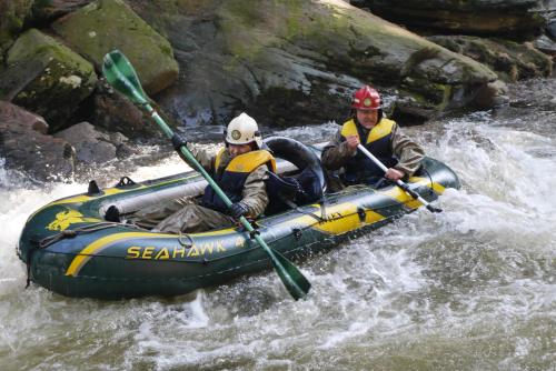 two people in a raft in a river at Birkut Szkoła Przetrwania 1 in Lasowka