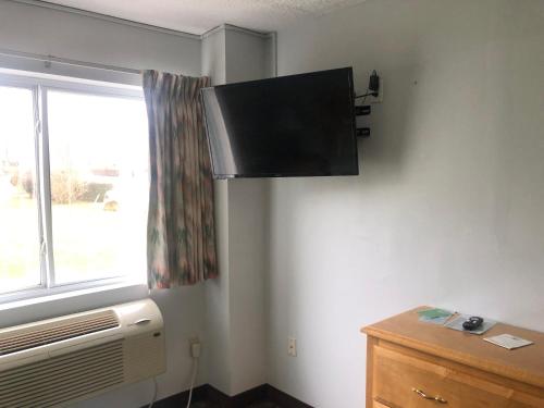 a room with a flat screen tv on the wall at The Atlantic House in Narragansett