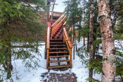 a staircase leading up to a cabin in the snow at Crow Creek in Girdwood