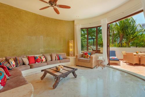 a living room with a couch and a table at Porto Playa Condo Hotel and Beach Club in Playa del Carmen
