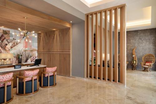 a lobby with a desk with a laptop on it at Secrets La Romana All-Inclusive Adult Only Resort & Spa in Bayahibe