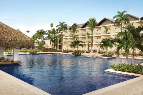 a swimming pool in front of a resort at Secrets La Romana All-Inclusive Adult Only Resort & Spa in Bayahibe