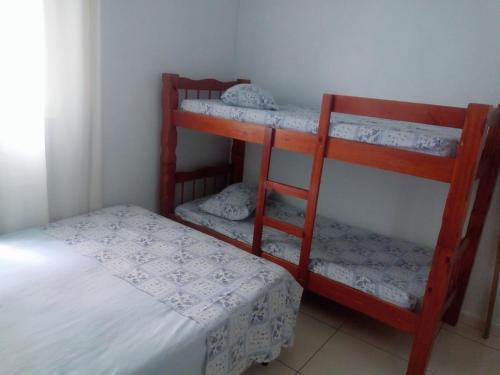 a room with two bunk beds and a bed at Pousada Brasil - Self Check-in in Aparecida
