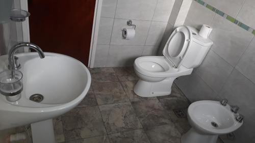 Casa amplia barrio privado Miramar في ميرامار: حمام مع مغسلة ومرحاض وشطاف