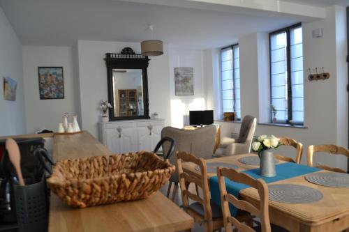 ein Wohnzimmer mit einem Tisch und Stühlen sowie ein Esszimmer in der Unterkunft Gîte Au Cœur de Cassel in Cassel