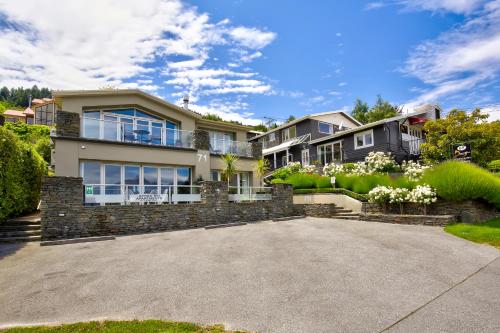 a large house with a driveway at Queenstown House Boutique Hotel & Apartments in Queenstown
