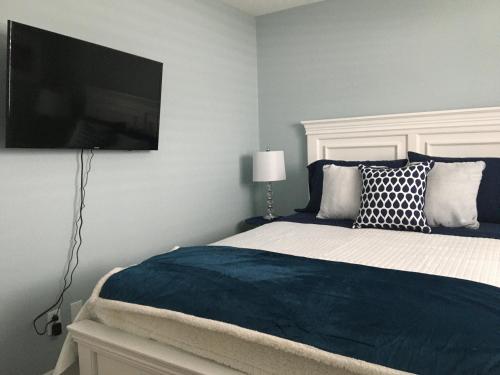 a bedroom with a bed with a flat screen tv on the wall at Hammer Haus II in Waterloo