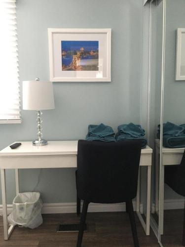 a desk with a chair and a picture on the wall at Hammer Haus II in Waterloo