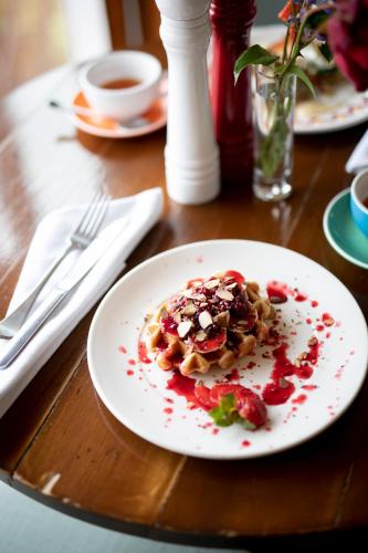 a plate of food on a wooden table at Queenstown House Bed & Breakfast and Apartments in Queenstown