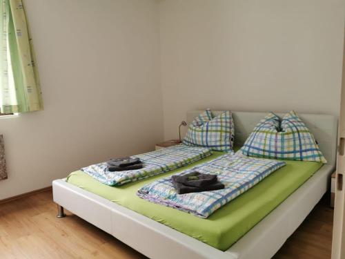 a bed with two pillows on it in a room at Apartment Fewo Irdning Pichlarn in Aigen im Ennstal