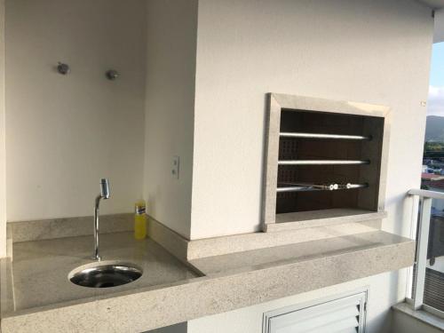 a kitchen counter with a sink and a window at Maravilhoso apartamento Beira-mar praia da cachoeira Florianópolis in Florianópolis