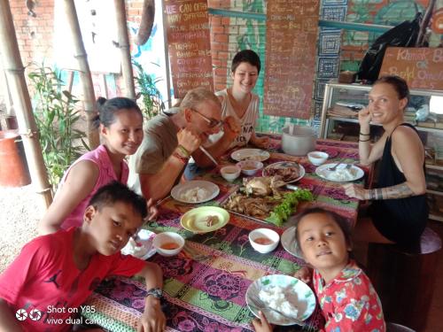 a group of people sitting around a table eating food at Ratanakiri Homestay & Jungle Trek in Banlung