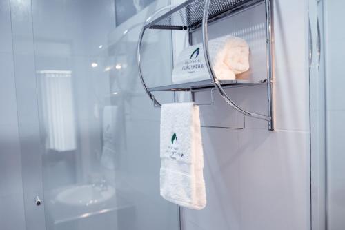 a towel hanging on a rack in a bathroom at Hotel Puñuykuna - Cajamarca in Cajamarca