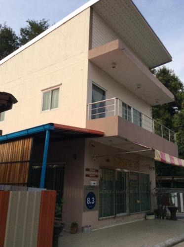 a building with a balcony on the side of it at Sorn Waree Home place in Kanchanaburi City