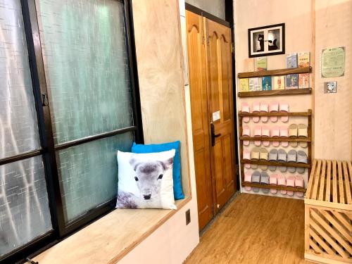 a room with a window with a pillow with a polar bear on it at Shadow house in Tainan