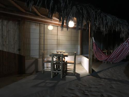 a patio with a table and a hammock in a building at Vistazul in Vichayito
