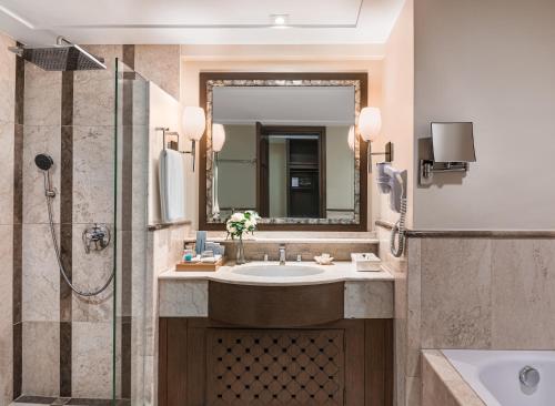 a bathroom with a sink and a shower at Henann Regency Resort and Spa in Boracay