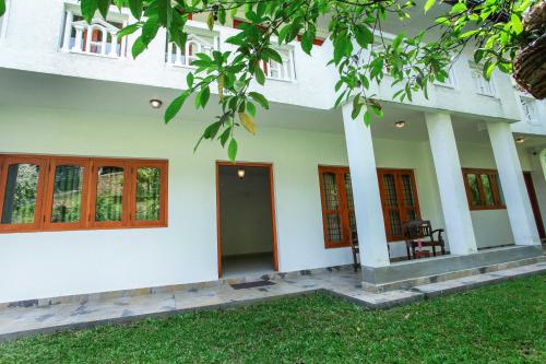 a building with columns and windows in a yard at 12 B 1/1, Lewella Rd, Kandy in Kandy