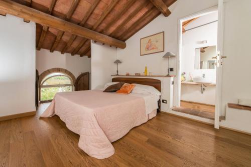 a bedroom with a bed in a room with a fireplace at L'Albero Di Gamelì in Chiusi