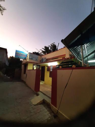a building with a sign on the side of it at Raghavi Tourist Home in Kanyakumari