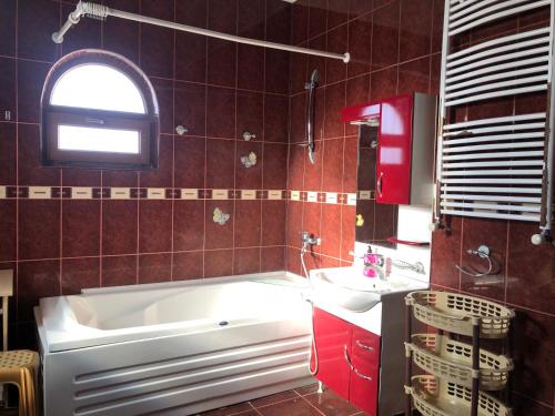 a bathroom with a white tub and a sink at Laguna Villa - Pool, Sauna, Events - at Bazaleti Lake in Karsimaantkari