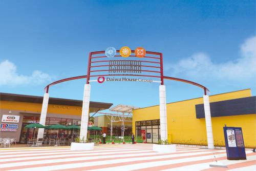a shopping center with a large sign in front of it at Living Inn Asahibashiekimae Premier in Naha