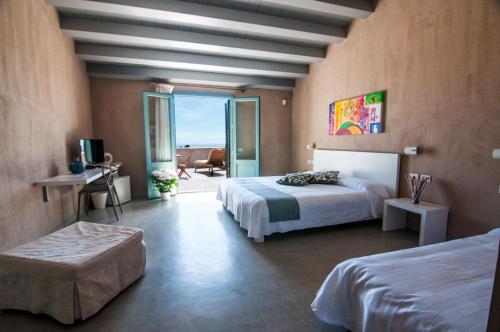 a bedroom with a bed, desk and television at Relais Casina Miregia in Menfi