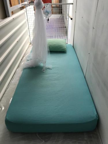 a bride sitting on a mattress in a room at Yez Yez Yez All Good Hostel in Yogyakarta