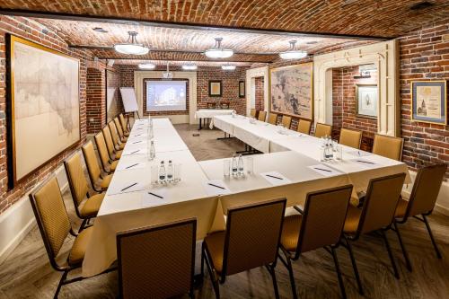 a large room with a long table and chairs at Hotel Atlas Deluxe in Lviv