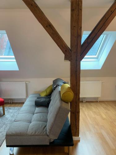 a couch sitting in a living room with skylights at Mariazeller Rooms in Mariazell