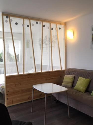 a living room with a couch and a table at Les Jardins du Golf in Metz