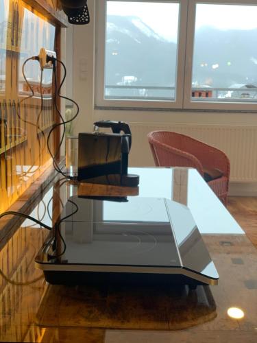 a glass table with a machine on top of it at Mariazeller Rooms in Mariazell
