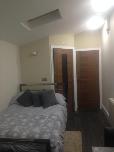 a bedroom with a bed and a wooden door at Cauldwell Villas in South Shields