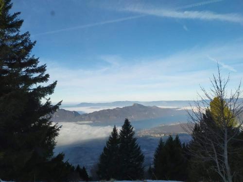 a view of a mountain range with trees and clouds at Les Terrasses de Tresserve in Aix-les-Bains