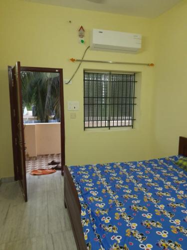 a bedroom with a bed and a window at Raghavi Tourist Home in Kanyakumari
