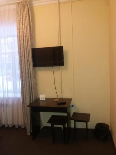 a desk in a hotel room with a window at Гостиница "SEMEY-CITY" in Semey