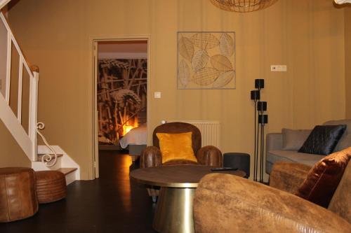 a living room with a table and chairs at Label Semois Gite rural 3 épis in Bouillon